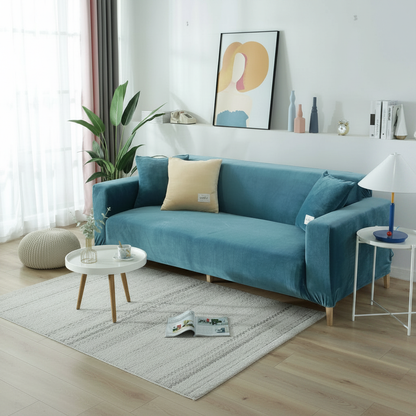 Lake blue velvet full stretch sofa slipcover fitted on a 3-seater couch in a bright modern living room