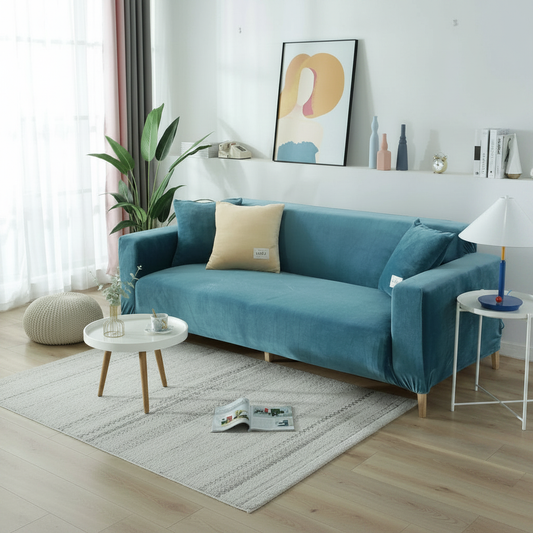Lake blue velvet full stretch sofa slipcover fitted on a 3-seater couch in a bright modern living room