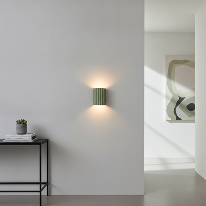 VaultGlow green fluted resin LED wall sconce mounted in a modern hallway lifestyle