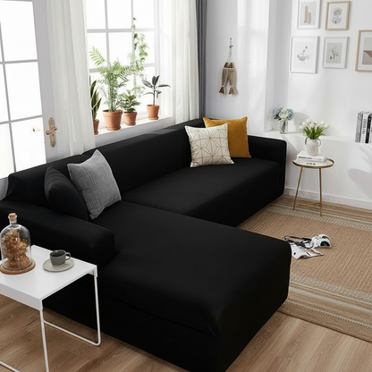 Black L-shaped sofa slipcover styled in a modern living room