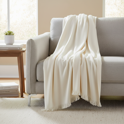 Off-White Soft Throw Blanket draped over a sofa in a modern living room