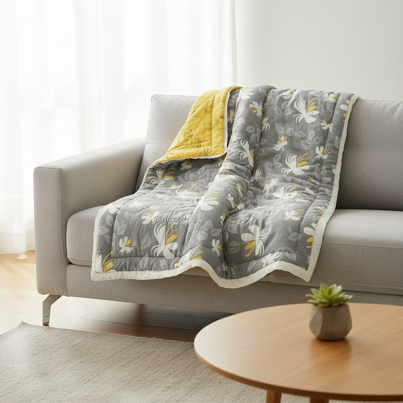 Elegant floral summer blanket draped over a sofa in a modern room