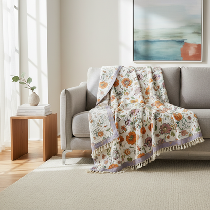 Wildflower Botanical Reverie Cotton Blanket draped on a sofa in a modern living room